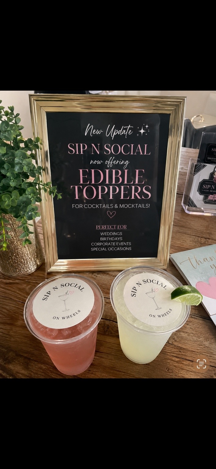 Edible drink toppers sign beside signature cocktails